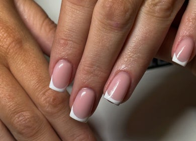 Elegant French manicure at NAIAA Studio, Oakham, England, GB, showcasing neat pink nails with white tips.