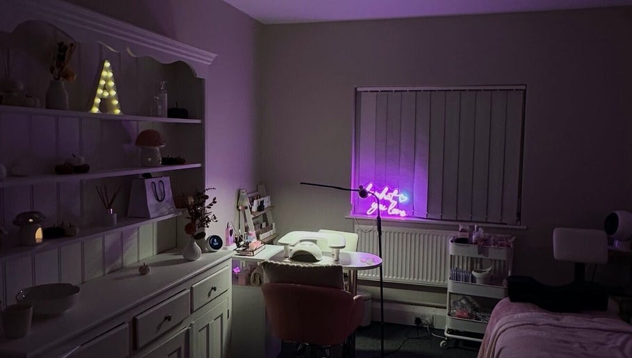 NAIAA Studio in Oakham, England, GB, with cozy decor and a glowing neon sign for a relaxing beauty experience.