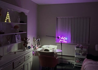 NAIAA Studio in Oakham, England, GB, with cozy decor and a glowing neon sign for a relaxing beauty experience.