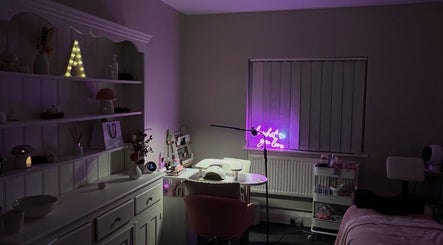 NAIAA Studio in Oakham, England, GB, with cozy decor and a glowing neon sign for a relaxing beauty experience.
