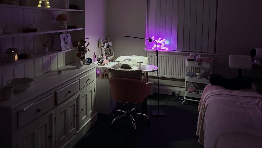 Cozy interior of NAIAA Studio, Oakham, England, featuring a lit workstation and plush seating.