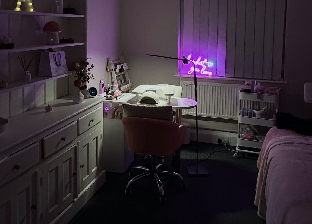 Cozy interior of NAIAA Studio, Oakham, England, featuring a lit workstation and plush seating.