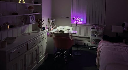 Cozy interior of NAIAA Studio, Oakham, England, featuring a lit workstation and plush seating.