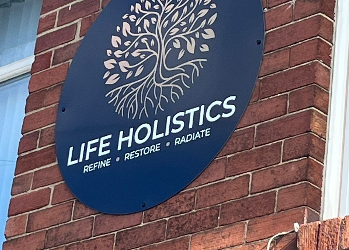 Life Holistics sign on brick wall, North Shields, England, GB.