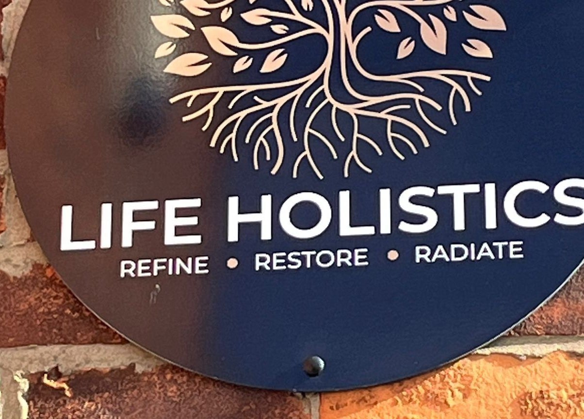 Life Holistics sign on a rustic brick wall in North Shields, England, GB.