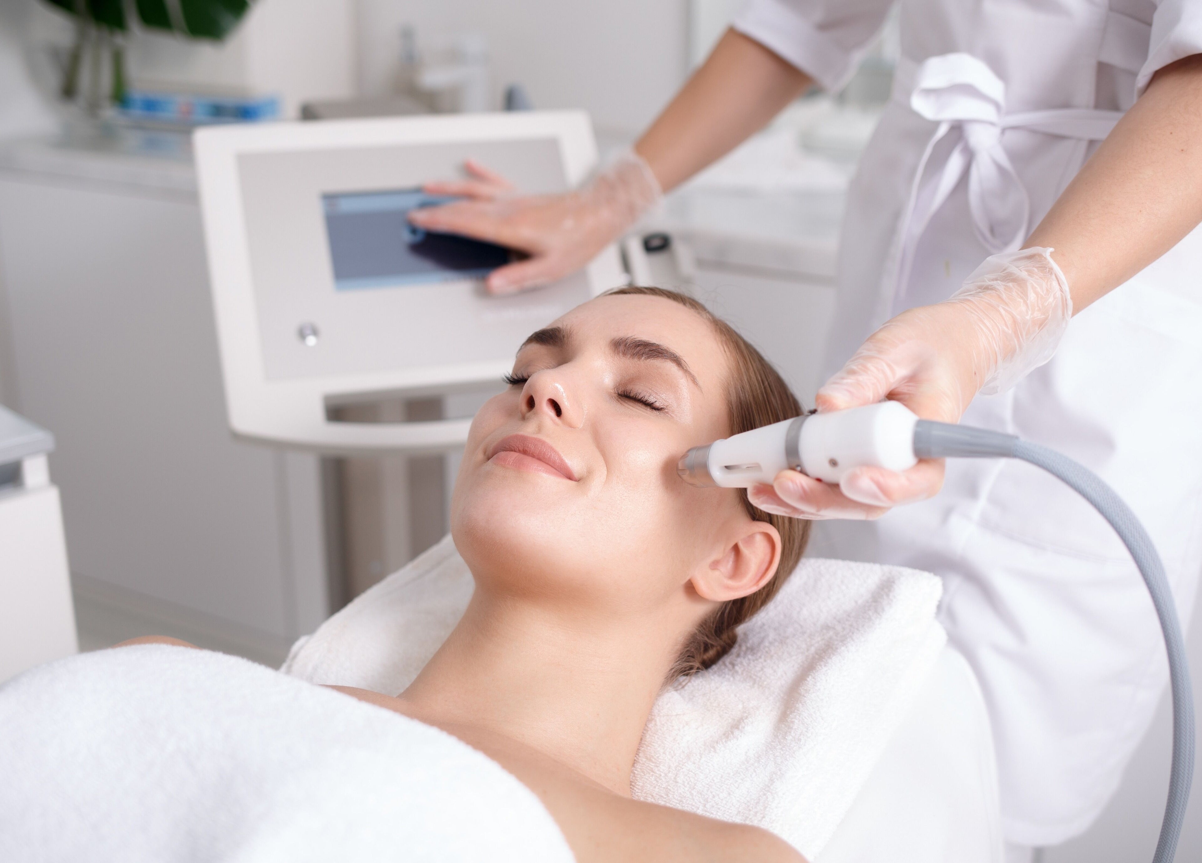 Woman enjoys skin treatment at Life Holistics, North Shields, England, GB. Expert care for glowing skin.