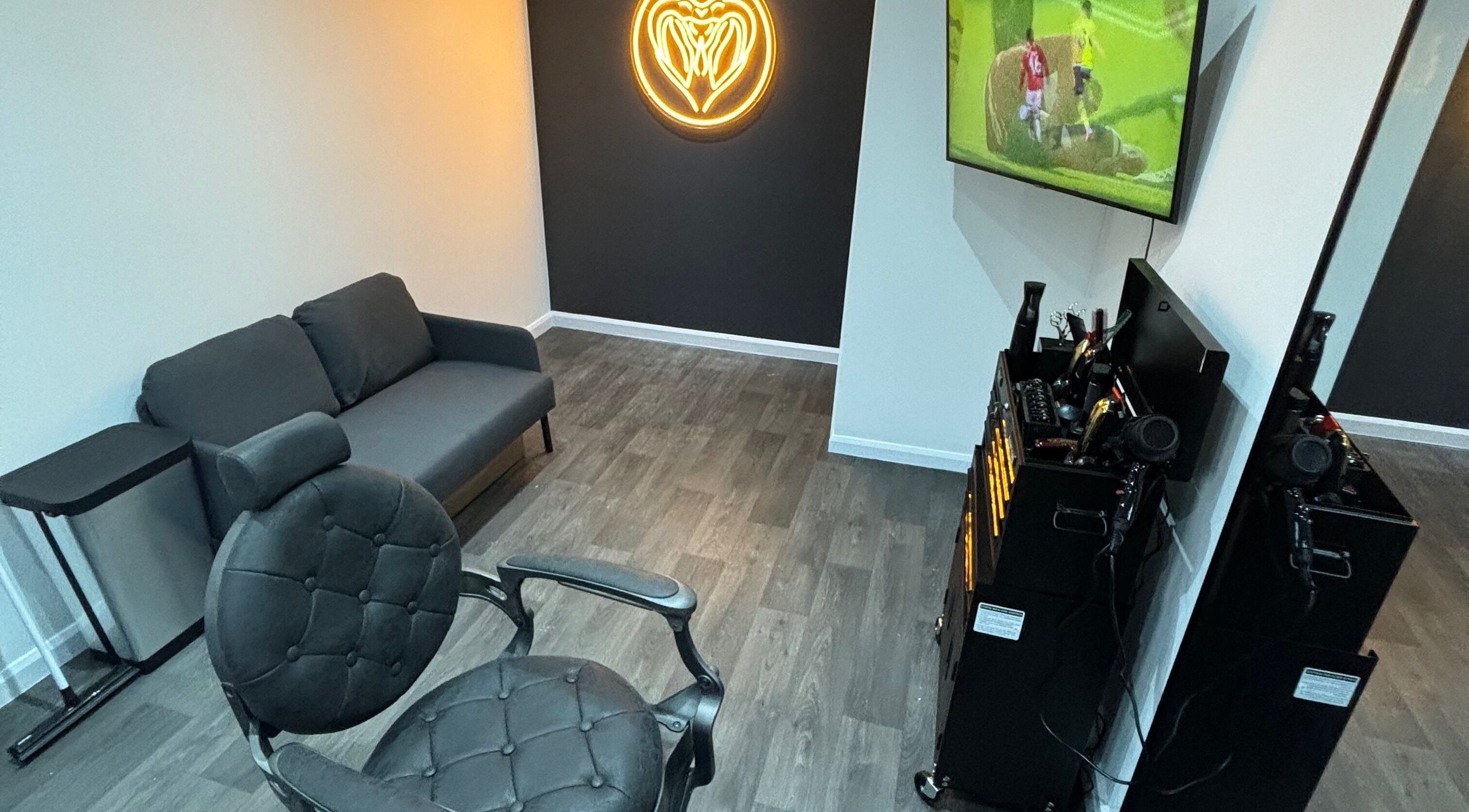 Modern interior of Snakebite Barbers in Hartlepool, England with stylish seating and tools.