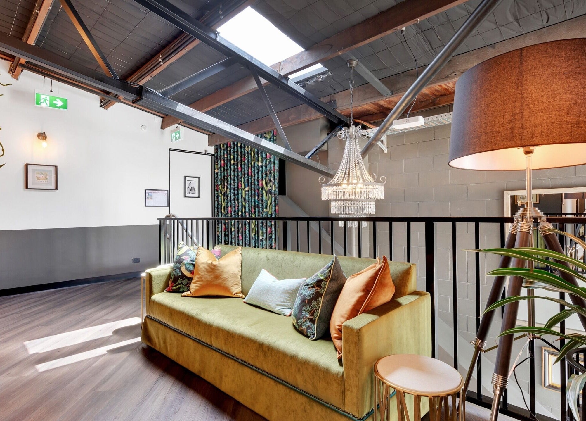 Stylish lounge area with plush sofa and chandelier at Studio D.E.W, West End, Queensland, AU.