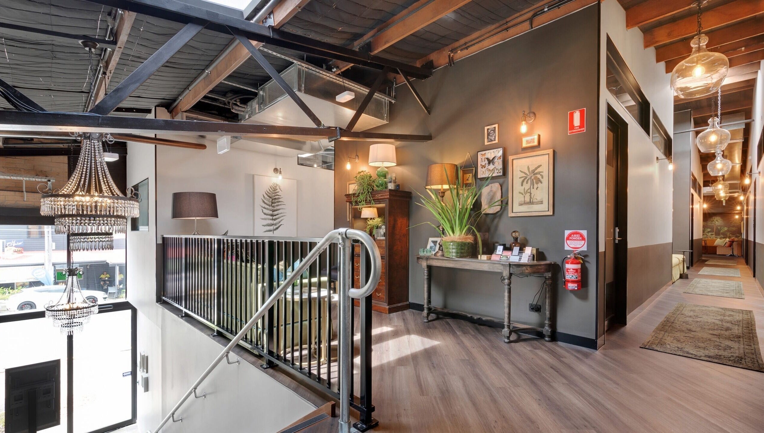 Elegant loft interior at Studio D.E.W, West End, Queensland, AU with stylish decor and chandelier.