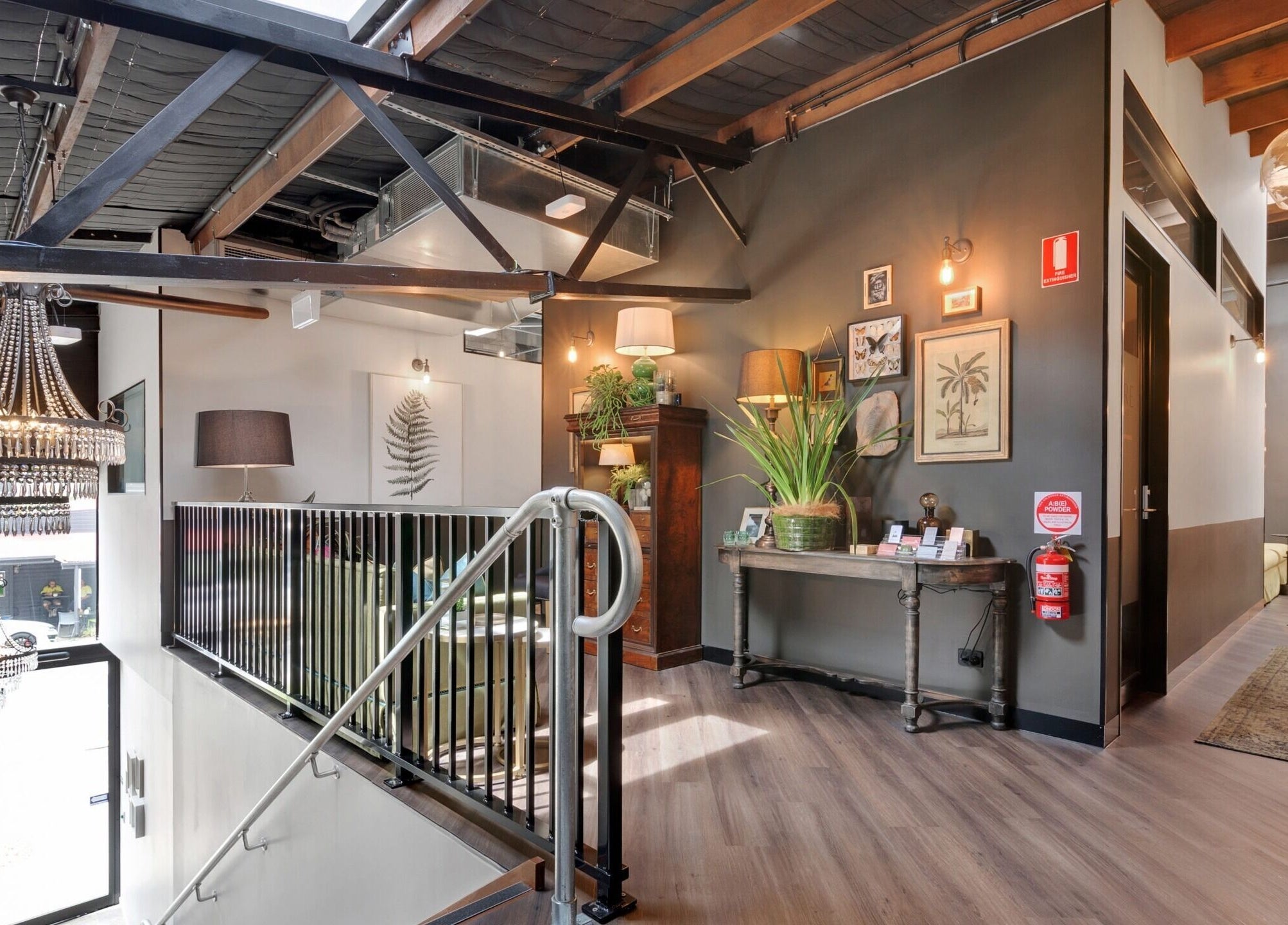 Elegant loft interior at Studio D.E.W, West End, Queensland, AU with stylish decor and chandelier.