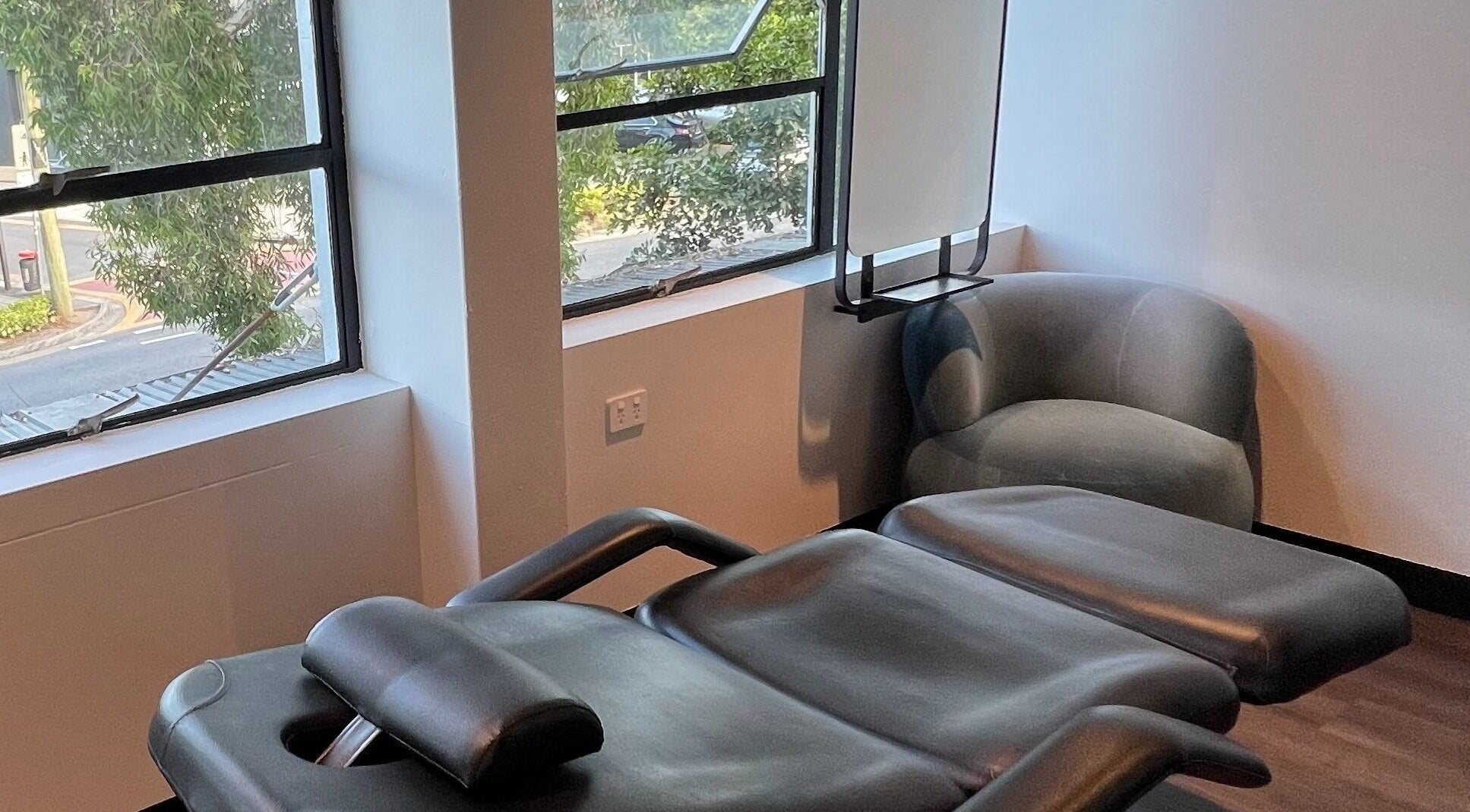 Relaxing massage chair in Studio D.E.W overlooking West End, Queensland, AU street view.