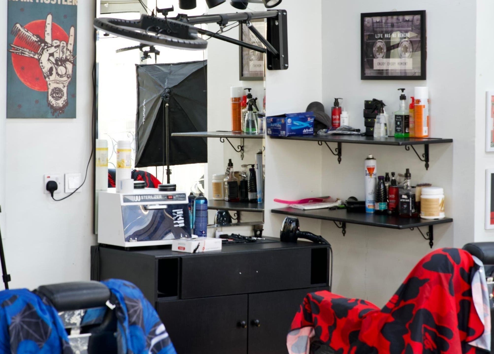 Barber shop interior at Faded in الخبر, المنطقة الشرقية, SA with styling chairs and products.