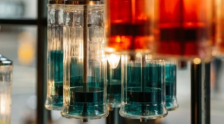 Stylish barber solution dispensers at Ted's Grooming Room: Marylebone - Duke Street, London, England, GB.