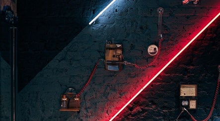 Modern grooming tools against neon-lit wall at Ted's Grooming Room: Baker Street - Dorset Street, London, England, GB.