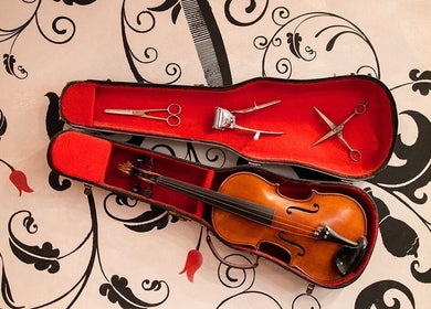 Violin in red case with grooming tools at Ted's Grooming Room: Baker Street - Dorset Street, London, England, GB.