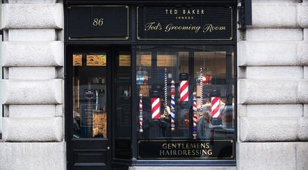Ted's Grooming Room: Moorgate exterior in London, England, GB, featuring classic barber poles and elegant signage.