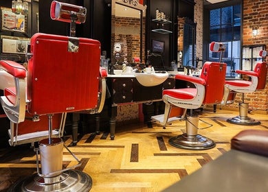 Stylish red barber chairs at Ted's Grooming Room: Covent Garden - Great Queen Street, London, England, GB.