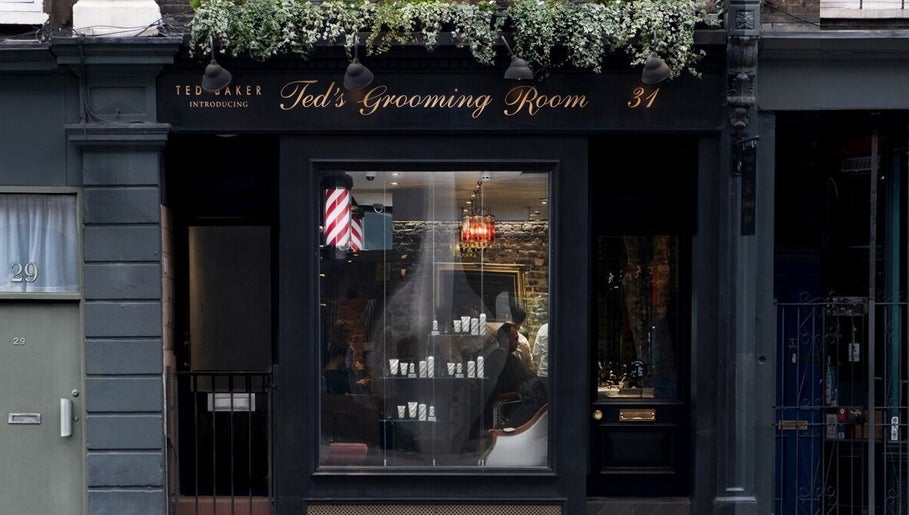 Elegant exterior of Ted's Grooming Room: Holborn - Theobald's Road in London, England, GB, showcasing stylish signage.