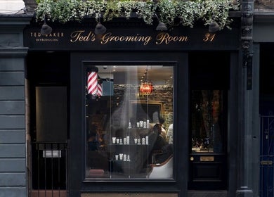 Elegant exterior of Ted's Grooming Room: Holborn - Theobald's Road in London, England, GB, showcasing stylish signage.