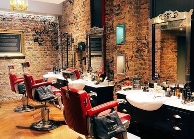 Elegant interior of Ted's Grooming Room: Holborn - Theobald's Road, London, England, GB with red barber chairs.