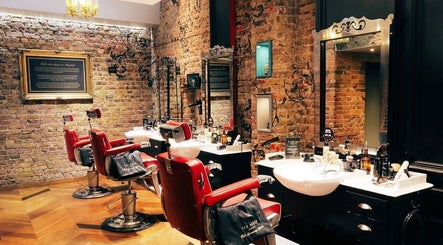 Elegant interior of Ted's Grooming Room: Holborn - Theobald's Road, London, England, GB with red barber chairs.