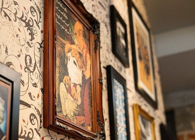 Decorative framed art on walls at Ted's Grooming Room: Holborn - Theobald's Road, London, England, GB.