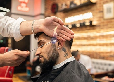 Ear flaming technique at Ted's Grooming Room: Westfield - Stratford, located in London, England, GB.