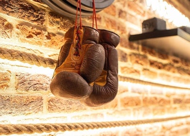 Leather boxing gloves hang in Ted's Grooming Room: Westfield - Stratford, London, England, GB.