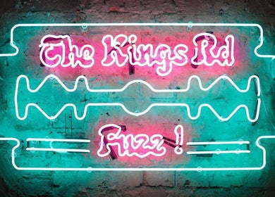 Neon sign of Ted's Grooming Room: Chelsea - King's Road in London, England, GB with vibrant colors.
