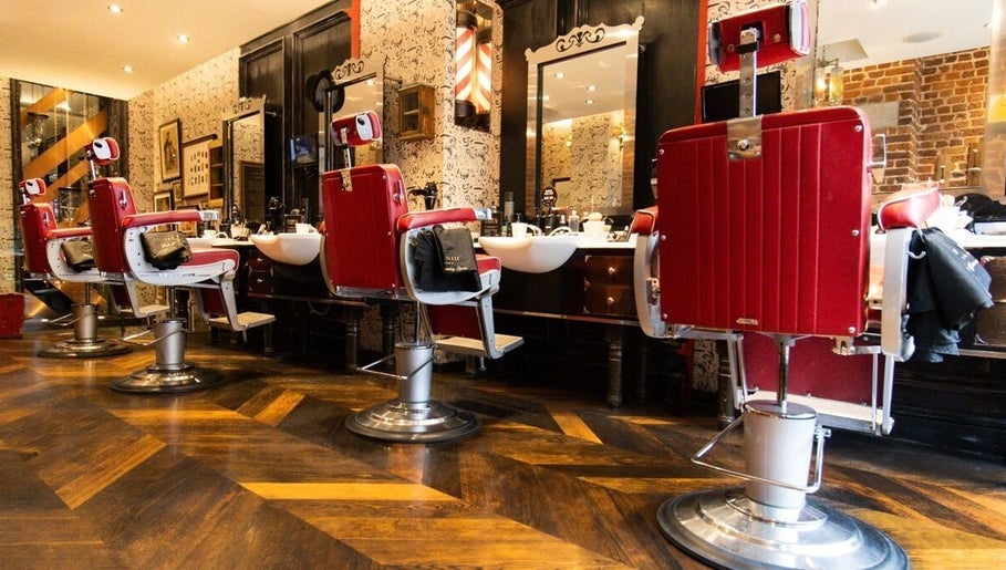 Red vintage barber chairs at Charlotte Street- Fitzrovia, Ted's Grooming Room, London, England, GB.