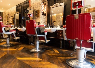 Red vintage barber chairs at Charlotte Street- Fitzrovia, Ted's Grooming Room, London, England, GB.