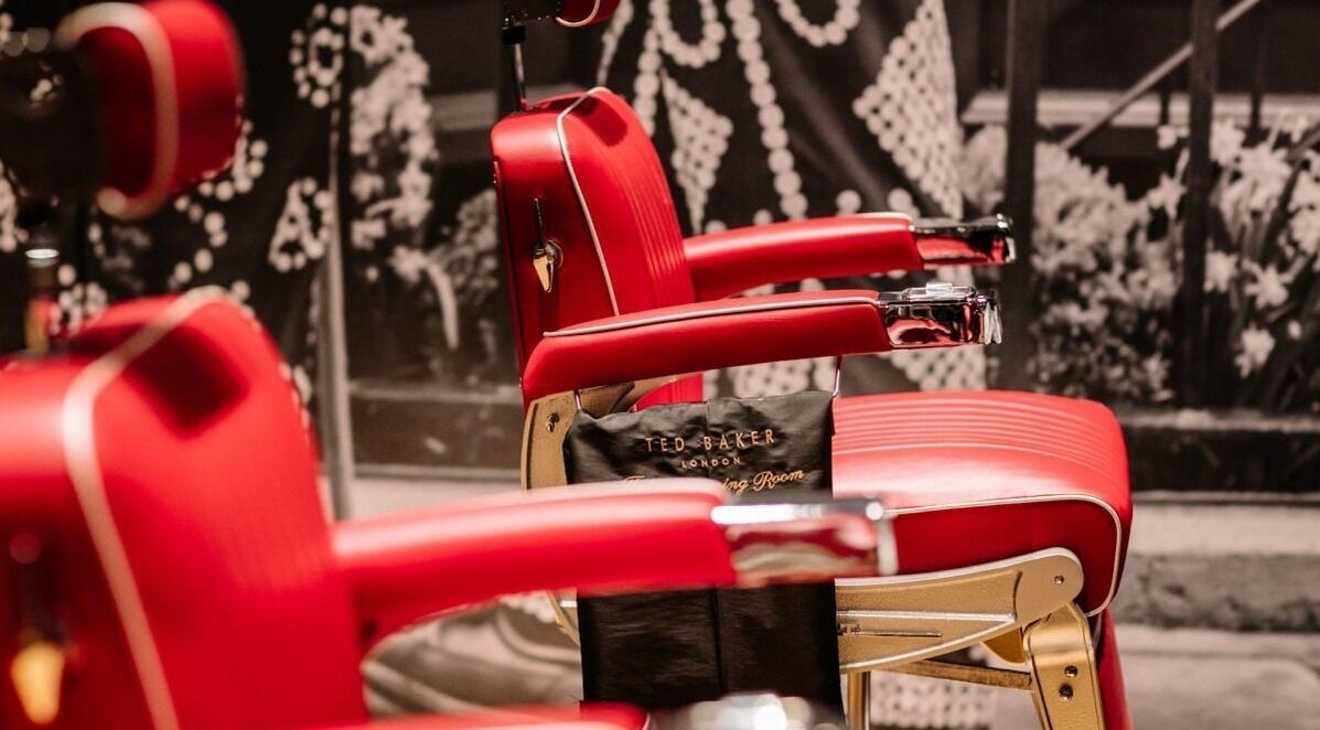 Red barber chairs at Ted's Grooming Room, One New Change - Bank, London, England, GB.