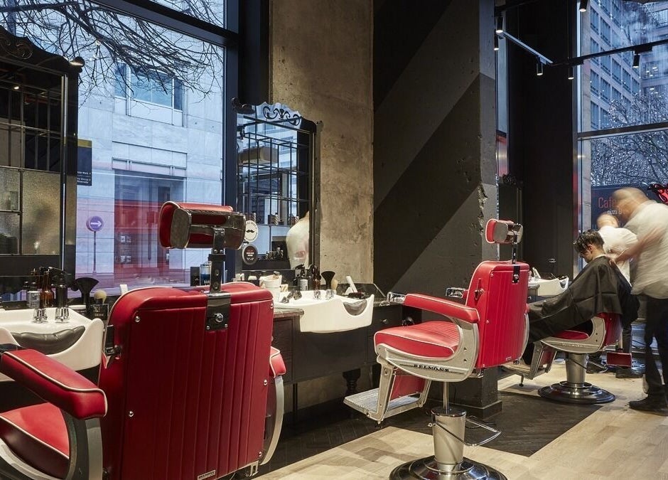 Stylish red barber chairs at Ted's Grooming Room, Cabot Place - Canary Wharf, London, England, GB.