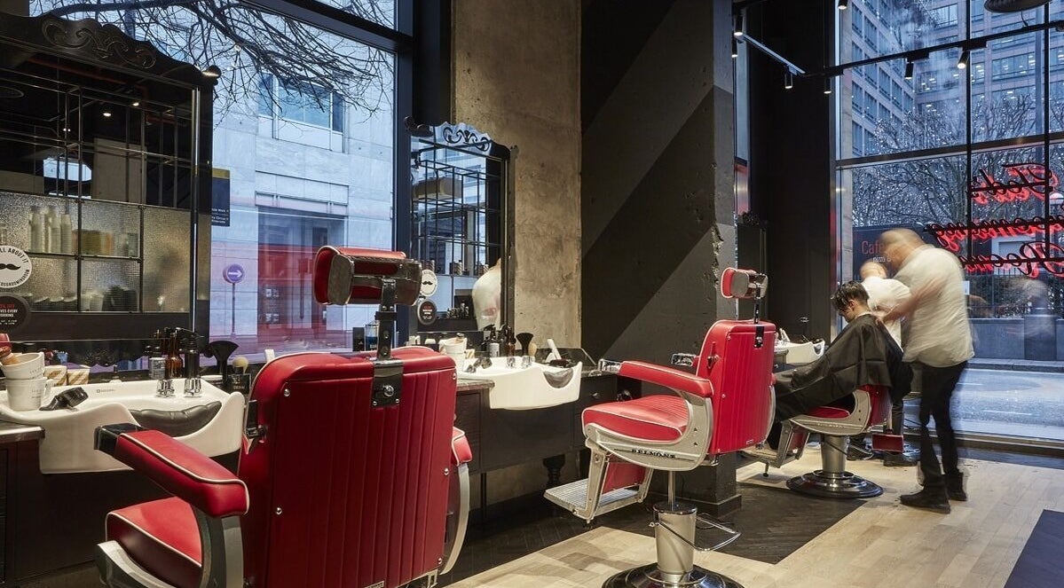 Stylish red barber chairs at Ted's Grooming Room, Cabot Place - Canary Wharf, London, England, GB.