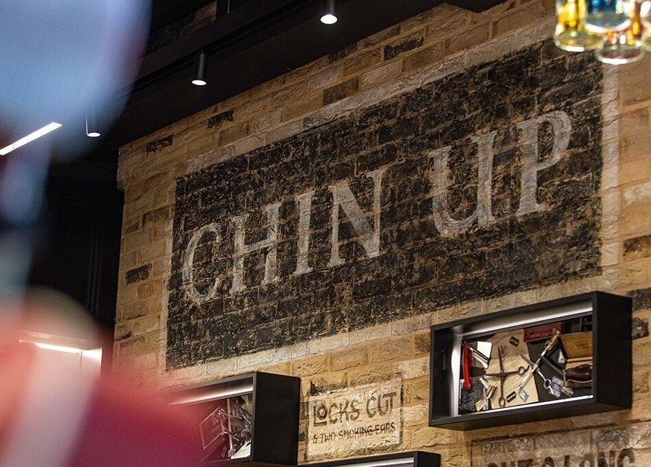 Chin Up sign on brick wall at London Bridge - Borough Yards, Ted's Grooming Room, London, England, GB.