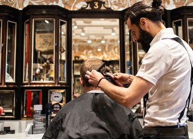 Stylist trimming hair at Moorgate, Ted's Grooming Room, London, England, GB in a classic setting.