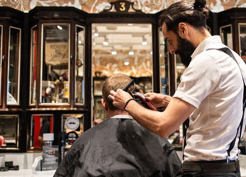 Stylist trimming hair at Moorgate, Ted's Grooming Room, London, England, GB in a classic setting.