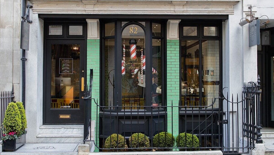 Exterior of Mortimer Street - Regents, Ted's Grooming Room in London, England, GB. Traditional storefront with green tiles.