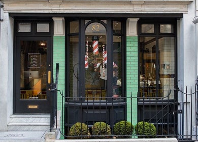 Exterior of Mortimer Street - Regents, Ted's Grooming Room in London, England, GB. Traditional storefront with green tiles.