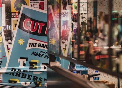 Colorful barber posters at Soho - Berwick Street, Ted's Grooming Room, London, England, GB.