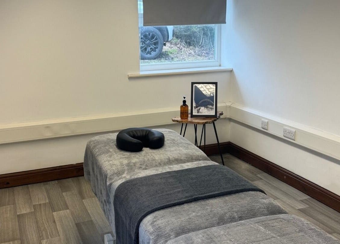 Calm massage room at Marley Massage, Colne, England, GB with a cozy massage table and serene decor.