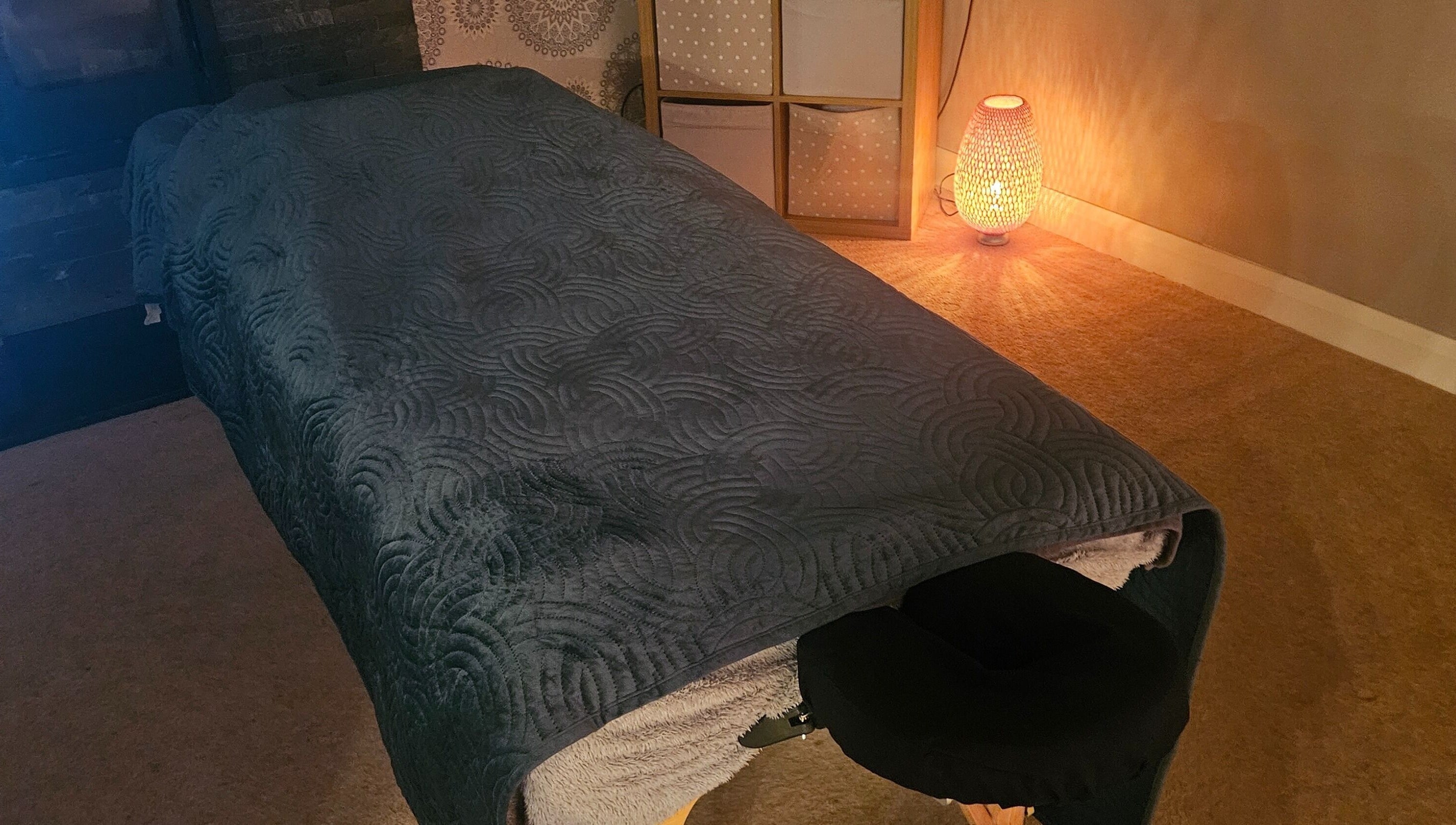 Relaxing massage room at Infinity Home Spa, Lurgan, Northern Ireland, GB, featuring a cozy treatment table.