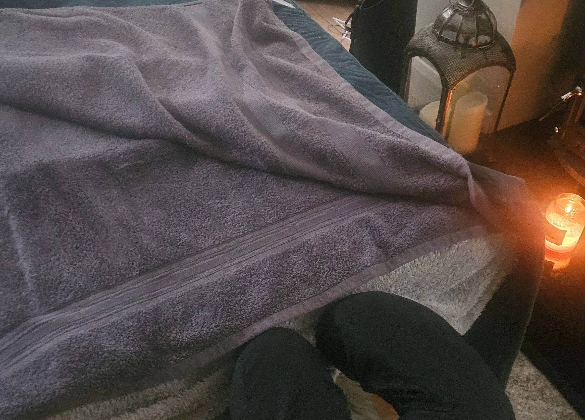 Soft towel and candlelit ambiance at Infinity Home Spa, Lurgan, Northern Ireland, GB.