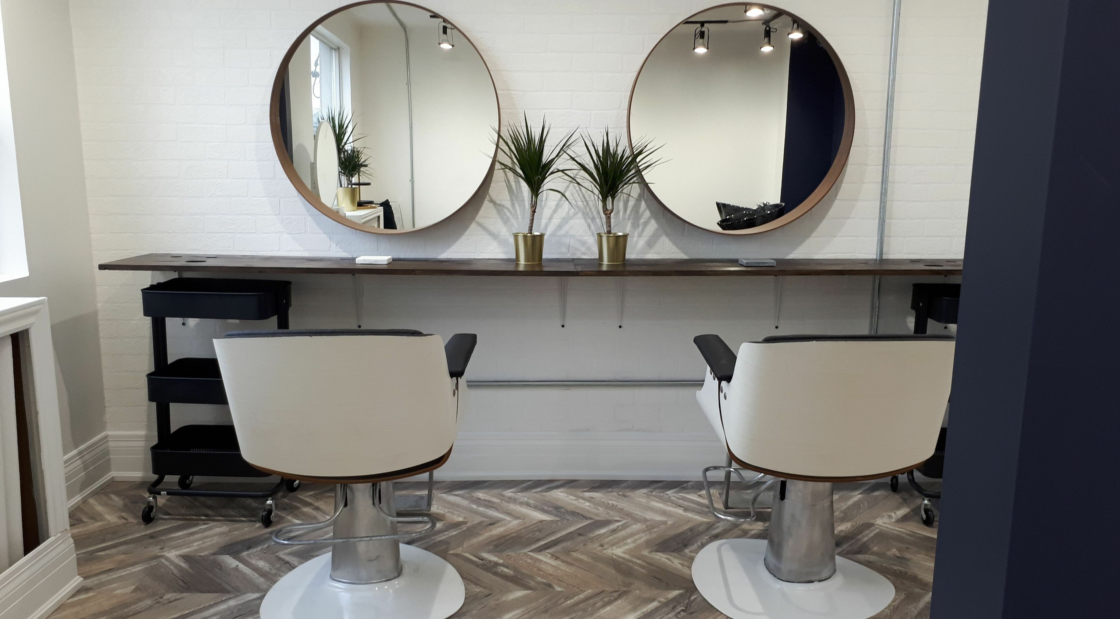 Modern styling chairs and mirrors at Guti Salon, Toronto, Ontario, CA reflect elegance and comfort.