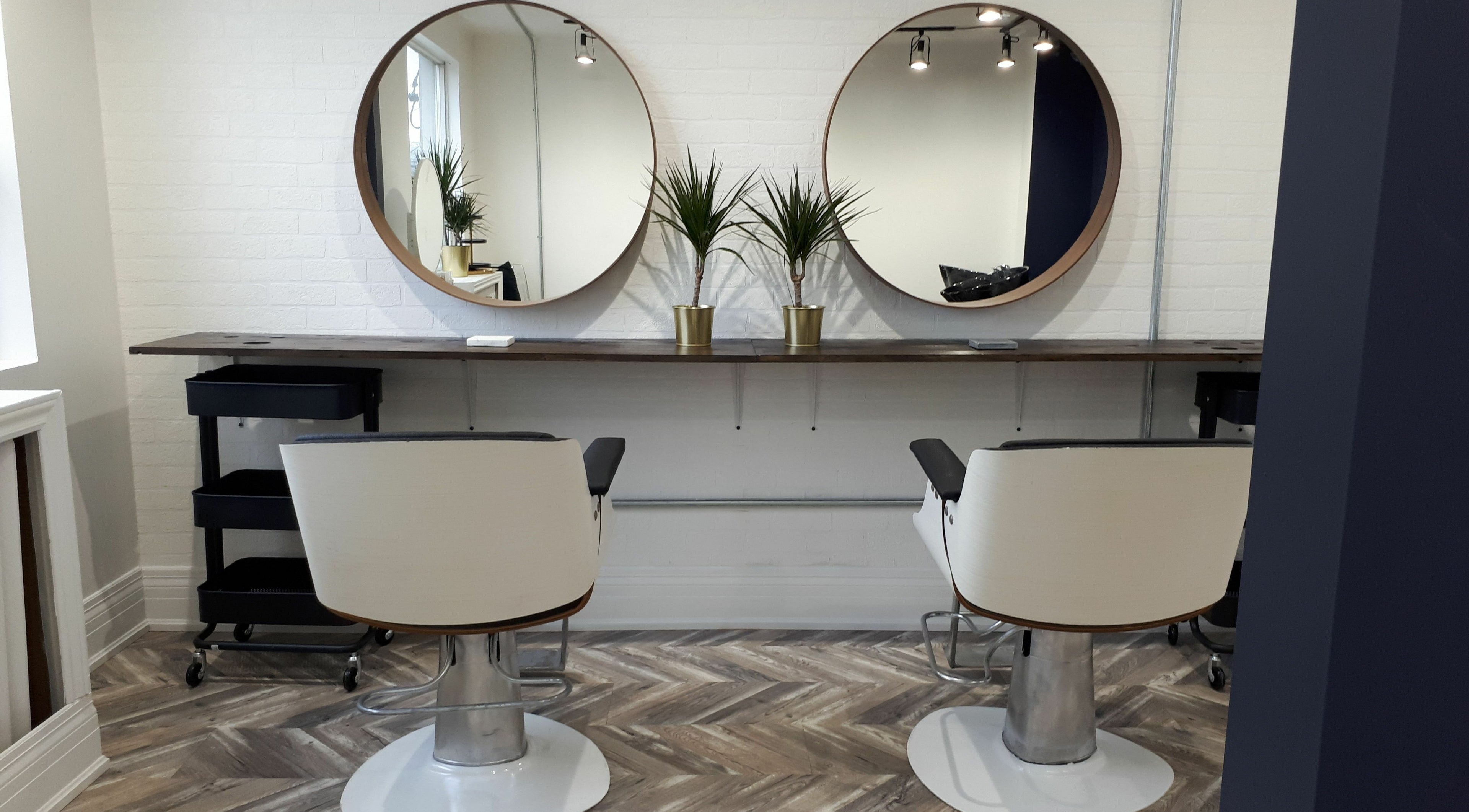 Modern styling chairs and mirrors at Guti Salon, Toronto, Ontario, CA reflect elegance and comfort.