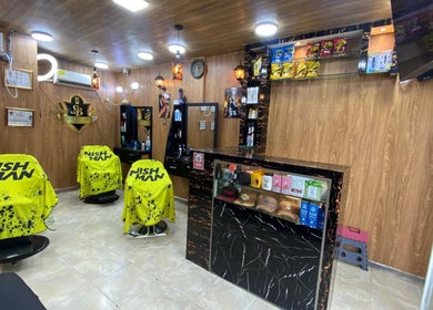 Modern interior of Shekinah Barber Shop in Barranquilla, Atlántico, CO with vibrant yellow salon chairs.