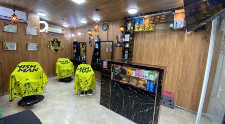 Modern interior of Shekinah Barber Shop in Barranquilla, Atlántico, CO with vibrant yellow salon chairs.