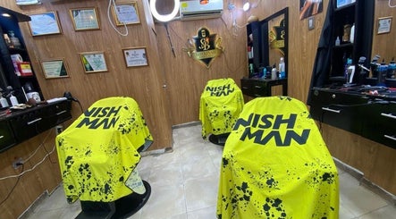 Interior of Shekinah Barber Shop in Barranquilla, Atlántico, CO, showcasing salon chairs and certificates.