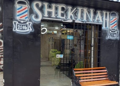 Entrance of Shekinah Barber Shop, Barranquilla, Atlántico, CO, showing modern signage and street view.