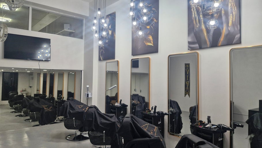 Modern interior of Kings Blade Barbershop in Randburg, Gauteng, ZA, featuring stylish chairs and mirrors.